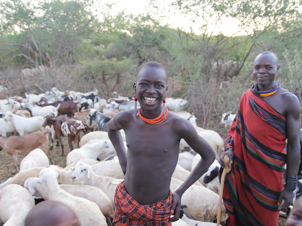 Karomajong in Karamoja Uganda smiling and wearing a Shuka in their daily life