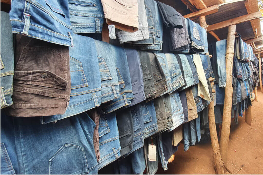 Markets in Uganda filled with second-hand clothing during a Karamoja travel experience