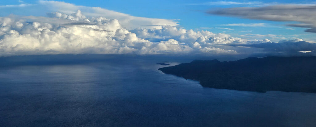 Ambon island appears out of nothing in the middle of the sea as seen from the plane