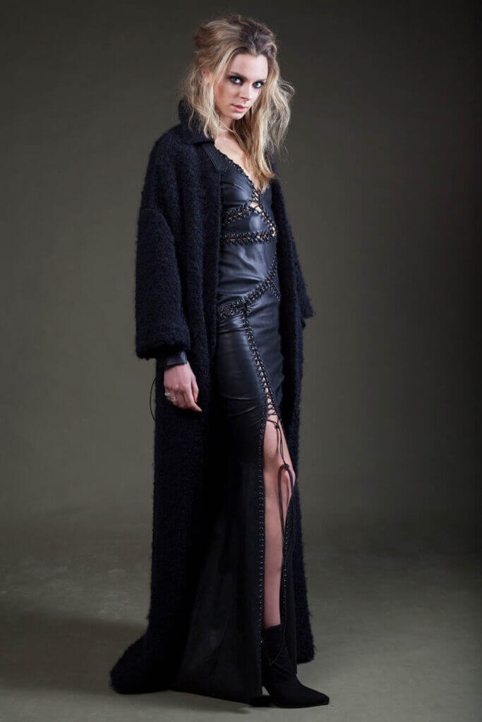 JANBOELO Model in black outfit and coat.