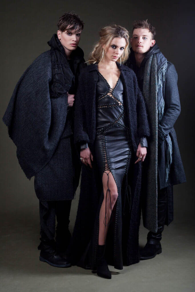 Stylish trio in dark, edgy fashion.