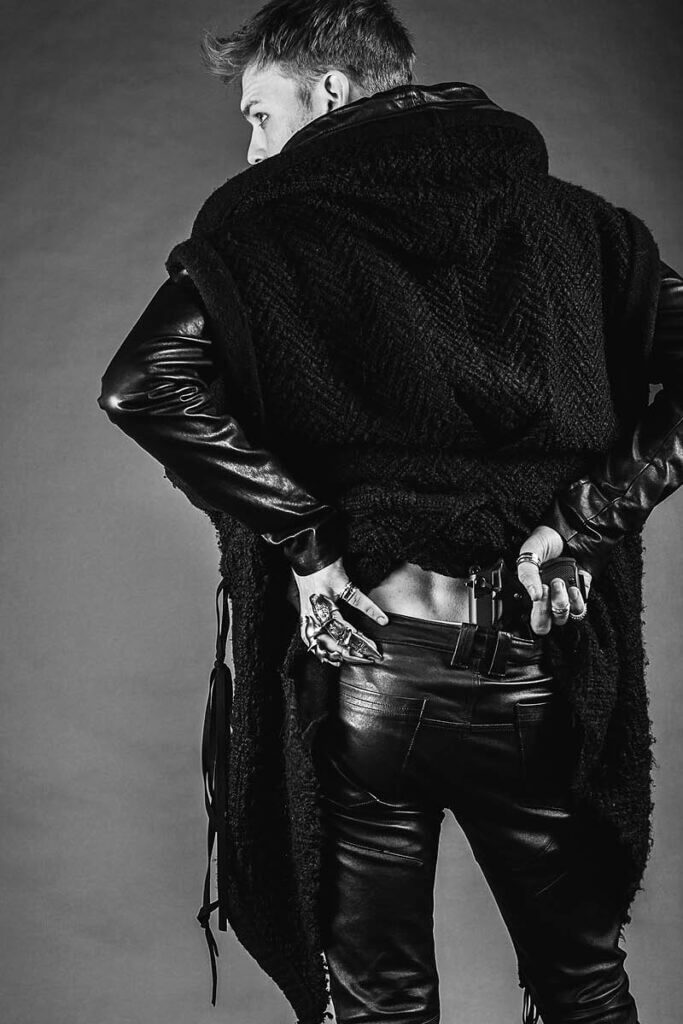 JANBOELO model in black outfit, dramatic pose.