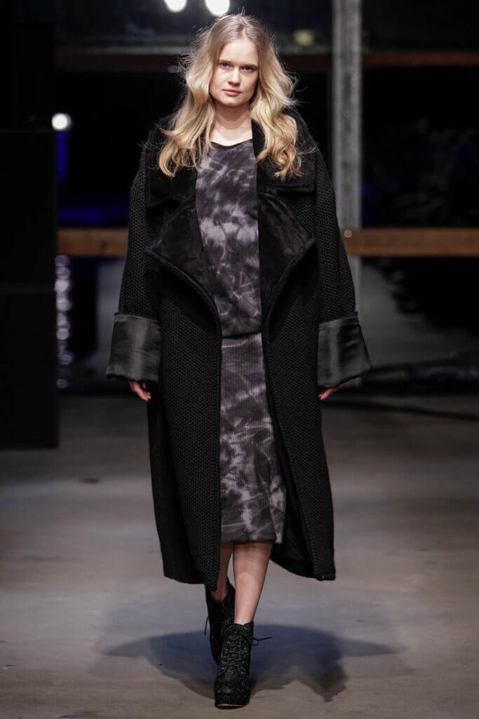 JANBOELO show Fall Winter 2013 2014 collection Model in oversized black coat.