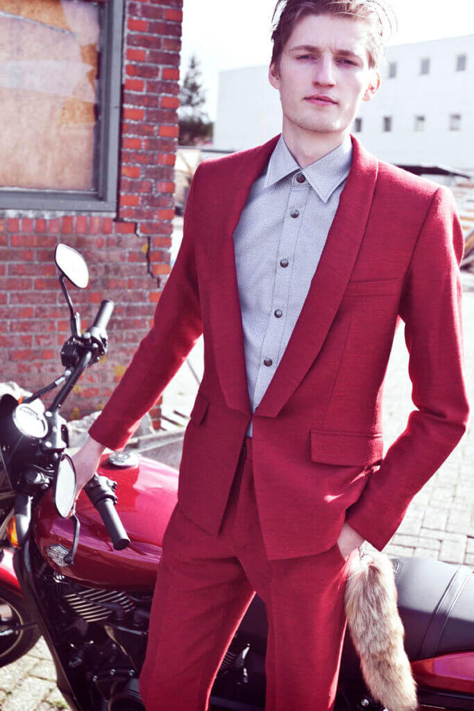JANBOELO Fall Winter 2015 collection presentation at Paradigm Groningen, Model in red suit with harley davidson motorcycle