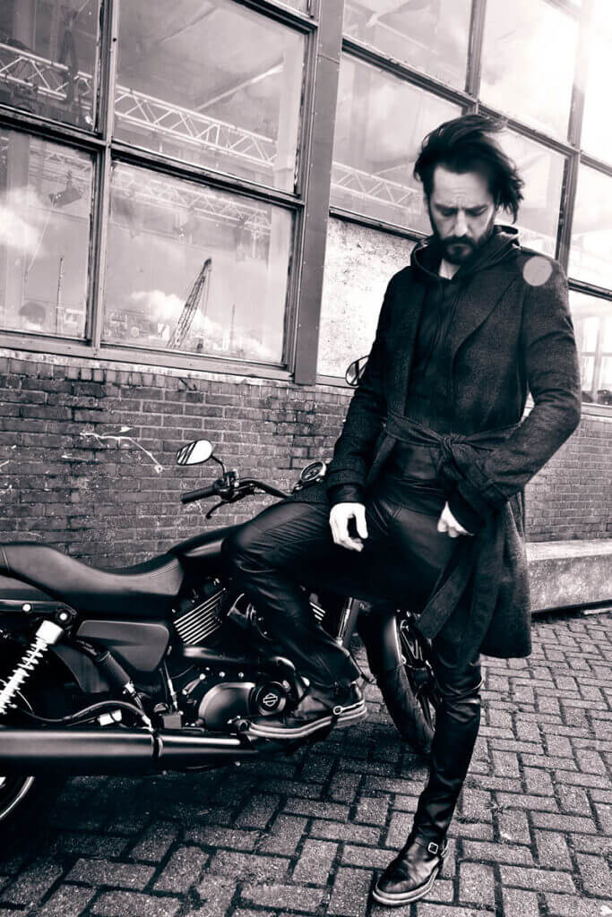 JANBOELO Fall Winter 2015 collection presentation at Paradigm Groningen, Model casually posing with harley davidson motorcycle