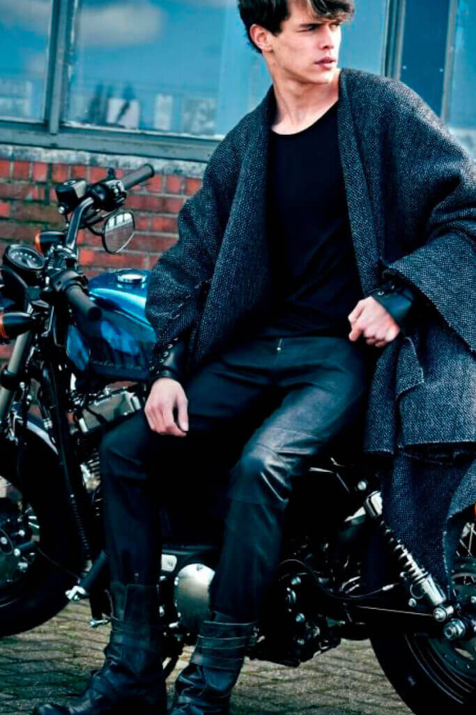JANBOELO Fall Winter 2015 collection presentation at Paradigm Groningen, Model posing on a harley davidson motorcycle wearing a wool cape
