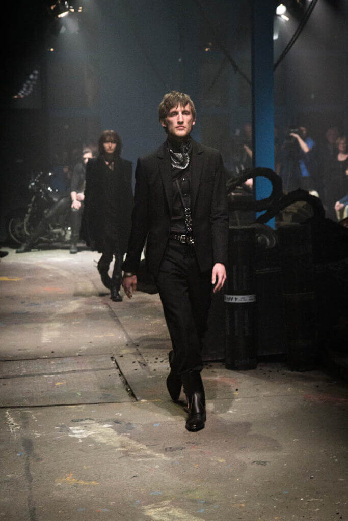 JANBOELO Fall Winter 2015 collection presentation at Paradigm Groningen, Model in black suit on the runway