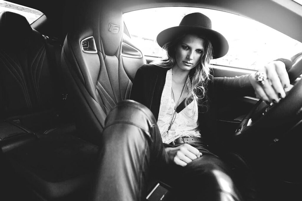 JANBOELO campaign spring summer 2017 woman in car, stylish attire, confident pose.