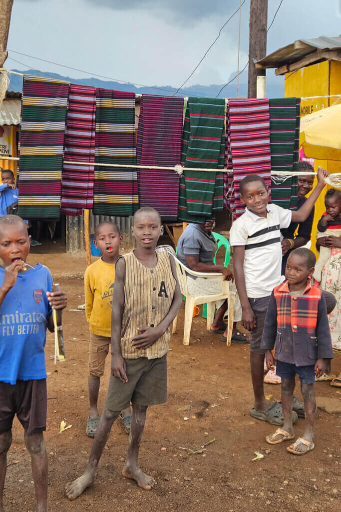 karamoja travel questions show the Local market in Namalu Karamoja Uganda with traditional shuka fabrics, reflecting daily life in Karamoja and cultural experiences in the region