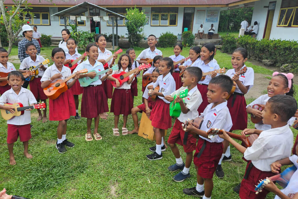 Children performing music at a school supported by Heka Leka in the Moluccas Indonesia