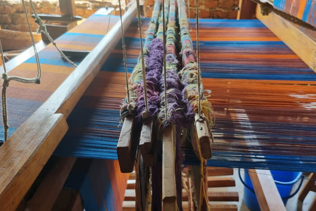 Traditional loom in Jinja showing all the work that goes with hand weaving