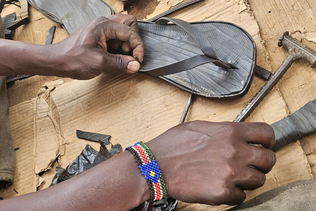 Making handmade sandals from recycled tyres in Uganda