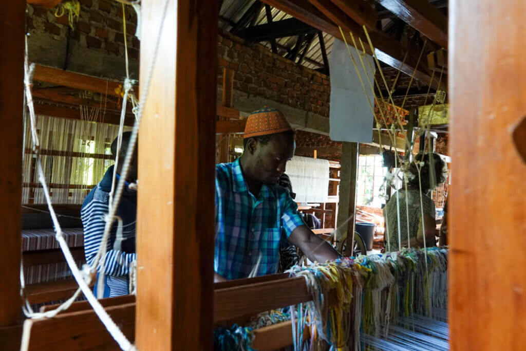 Weaver working on handmade textiles in Uganda