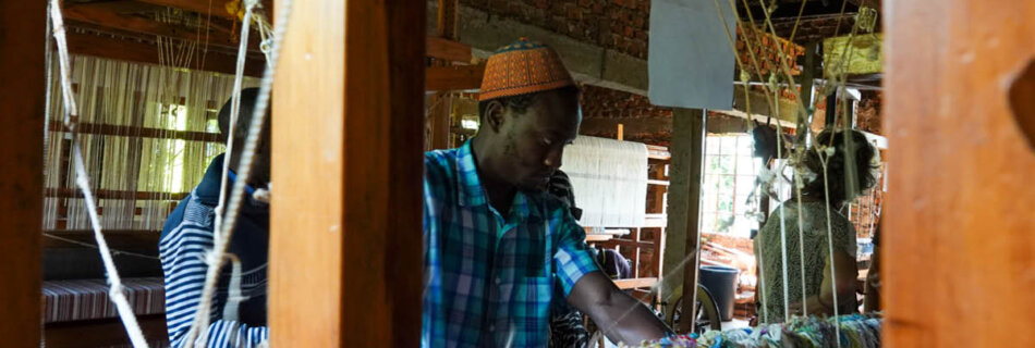 Weaver working on handmade textiles in Uganda