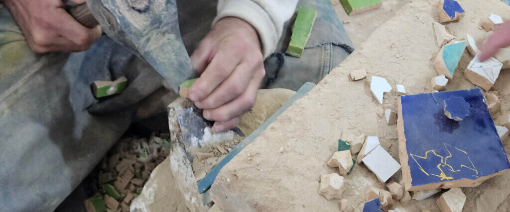 Craftsman working on handmade tiles in Fez Morocco