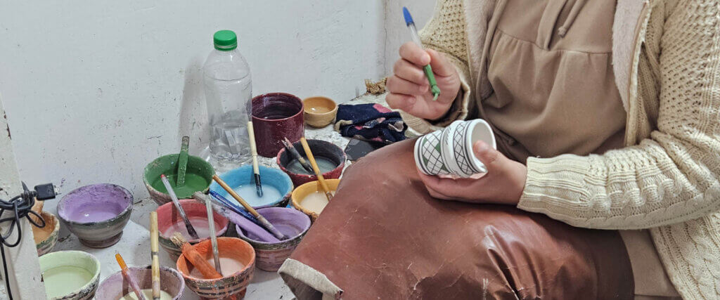 Local craftsmen creating handmade souvenirs in a traditional workshop in Fez, Morocco
