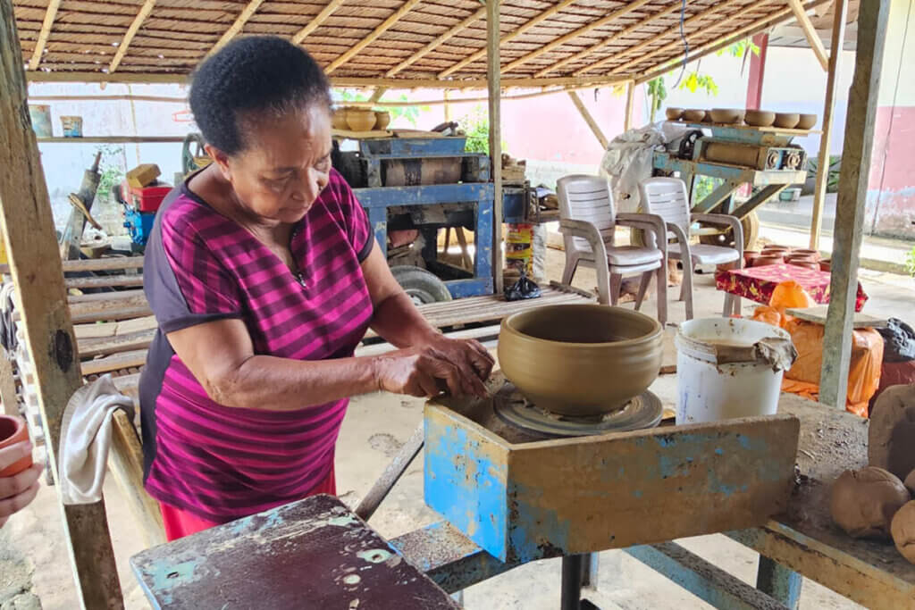 Woman shaping clay by hand on Saparua Island